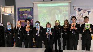 Y7 students holding Louie's book, Loki